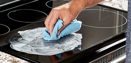 Use the glass or ceramic stove top safe pad or cloth to scrub in circular motions.