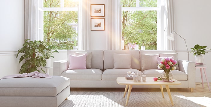 A clean living room with a couch, a footrest and a coffee table.