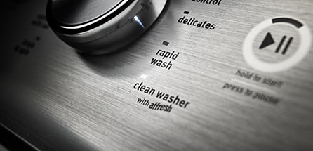 A washing machine dial set to the clean washer setting.