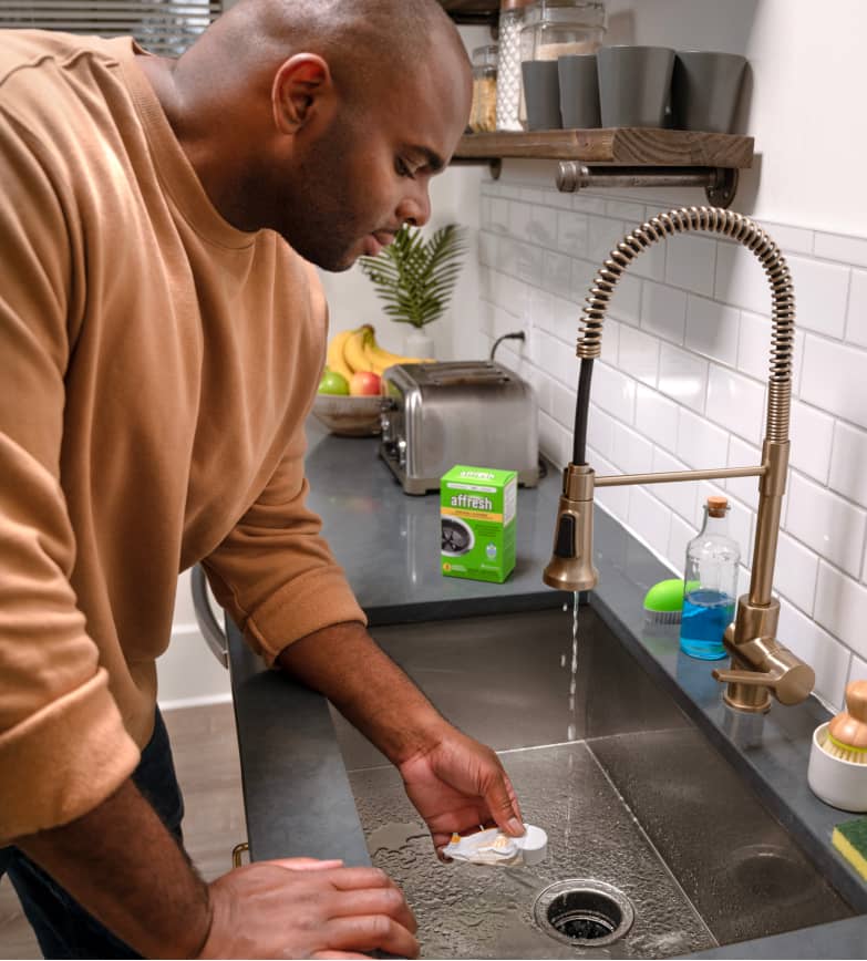 Man cleaning sink disposal