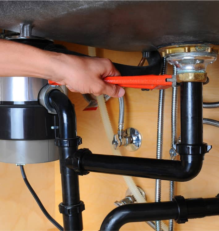 Person working under a sink