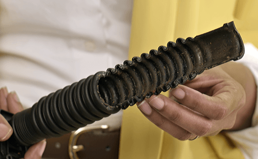 A person checking the washing machine drain pipe.