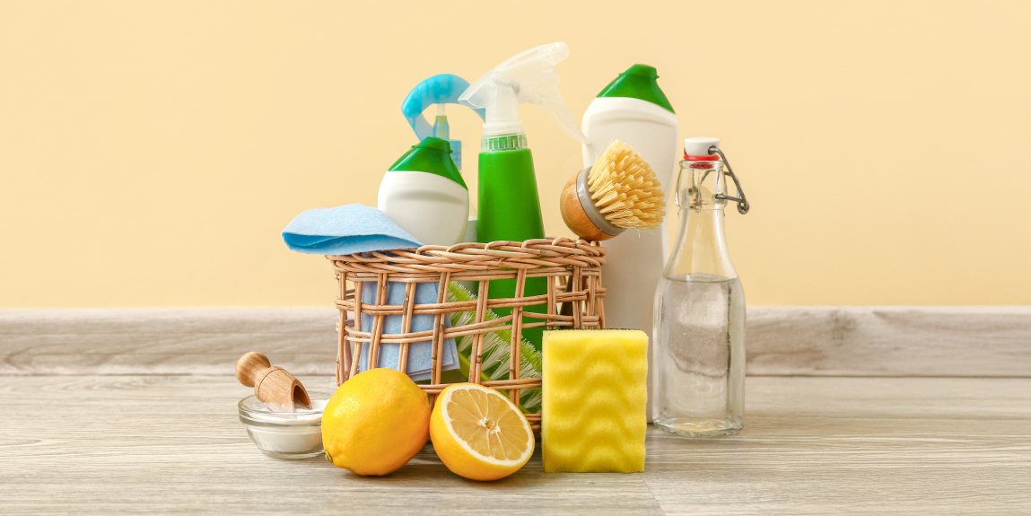 Natural and household cleaning products, like lemons, scrub brushes, sponges used to remove soap scum from appliances