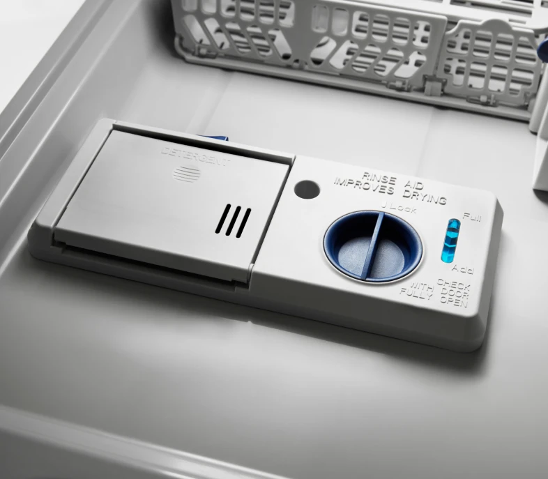 Dishwasher door dispenser showing the detergent cup and rinse aid compartment